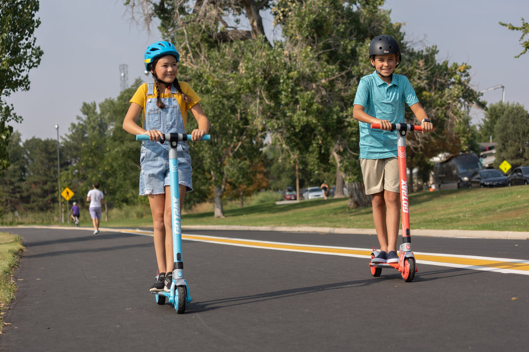 Two Children riding Vibe Foldable Electric Scooters for Teens in the park