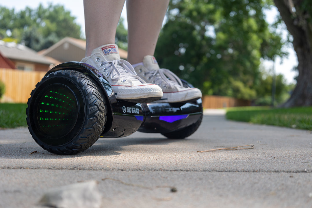 Child riding Black Nova Pro Hoverboard for Kids with LEDs and Infinity Wheels