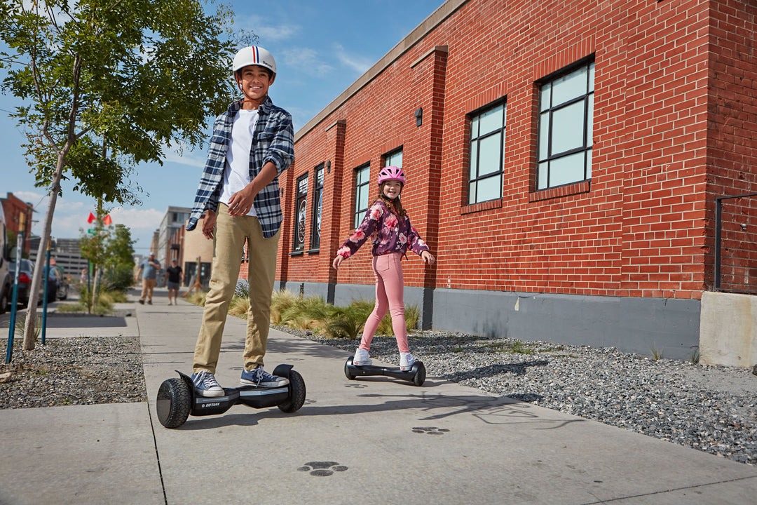 Two Children in Thousand Brand Helmets riding Infinity Pro Hoverboards