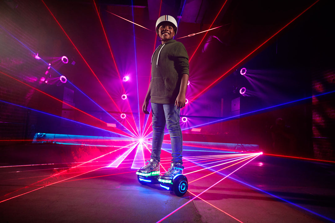 Child riding a GOTRAX Glide Chrome Bluetooth Hoverboard 6.5" with LEDs